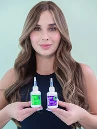 Mujer con cabello largo sosteniendo dos botellas Dutonic Loción Anticaída y Estimulante Capilar, una verde y otra morada.