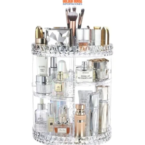 Organizador de maquillaje giratorio de acrílico transparente con botellas de perfume y brochas.