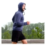Hombre corriendo con entrenador pulmonar bucal azul.