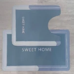Tapetes Duo Absorbente, azul, con diseño moderno y texto "SWEET HOME", ideal para baño.