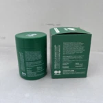 Tarro verde y caja de Capsulas Moto con información nutricional y de ingredientes.