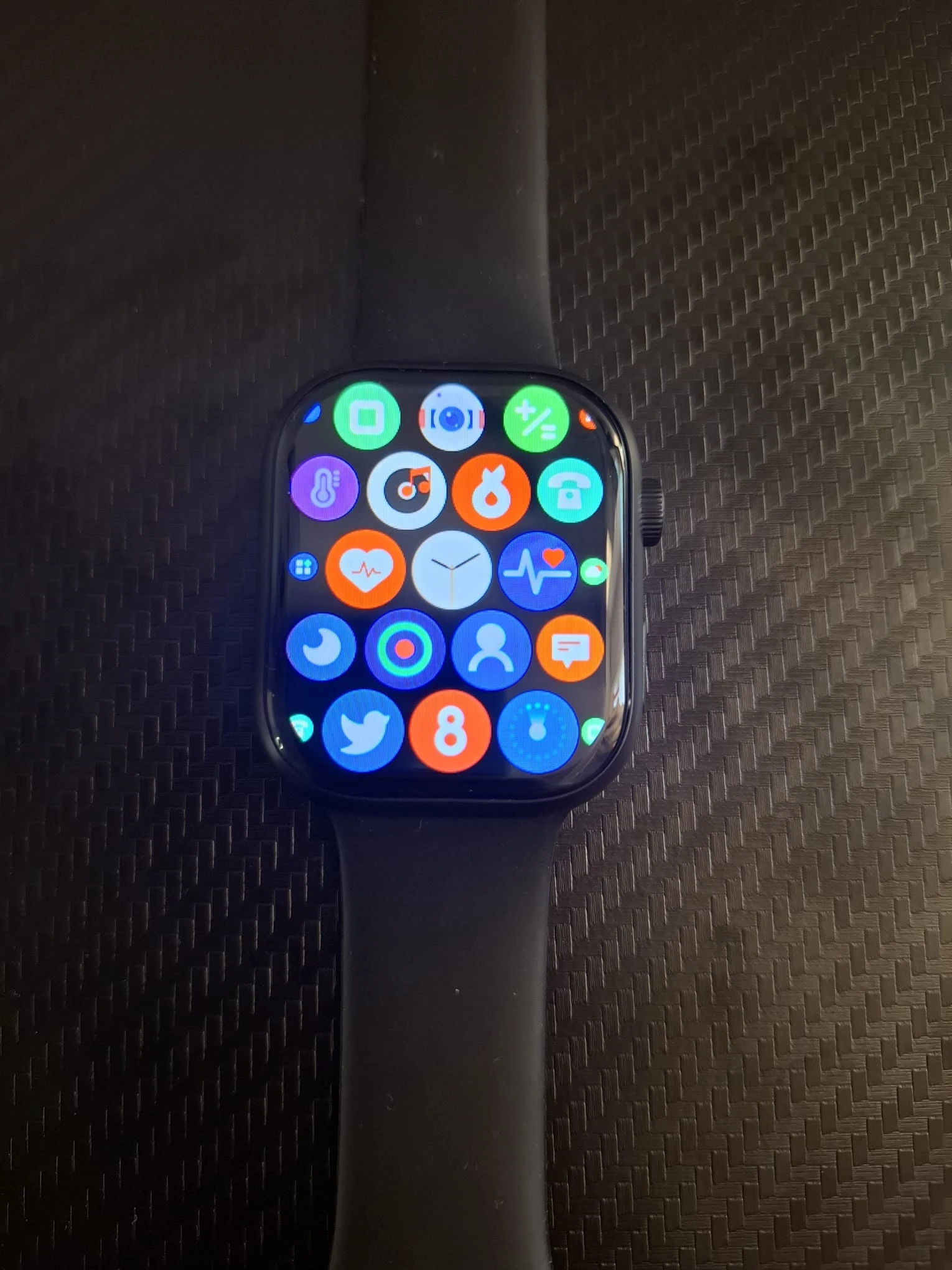 Reloj inteligente S9 negro con pantalla llena de íconos de aplicaciones, vista frontal.