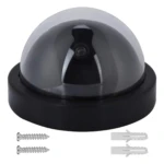 Cámara domo falsa negra con LED, incluye tornillos y taquetes para instalación.