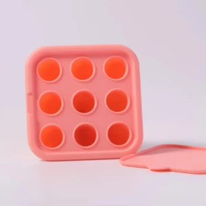 Set x2 chupones de fruta rosados, tipo pop it, con 9 burbujas y tapa a juego.