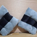 Cojines ergonómicos cuadrados, gris claro y negro, con textura suave, para mejorar postura en sillas.
