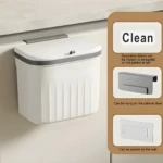 Canasta de basura blanca colgante para cocina con tapa hermética y ganchos para puerta o pared.