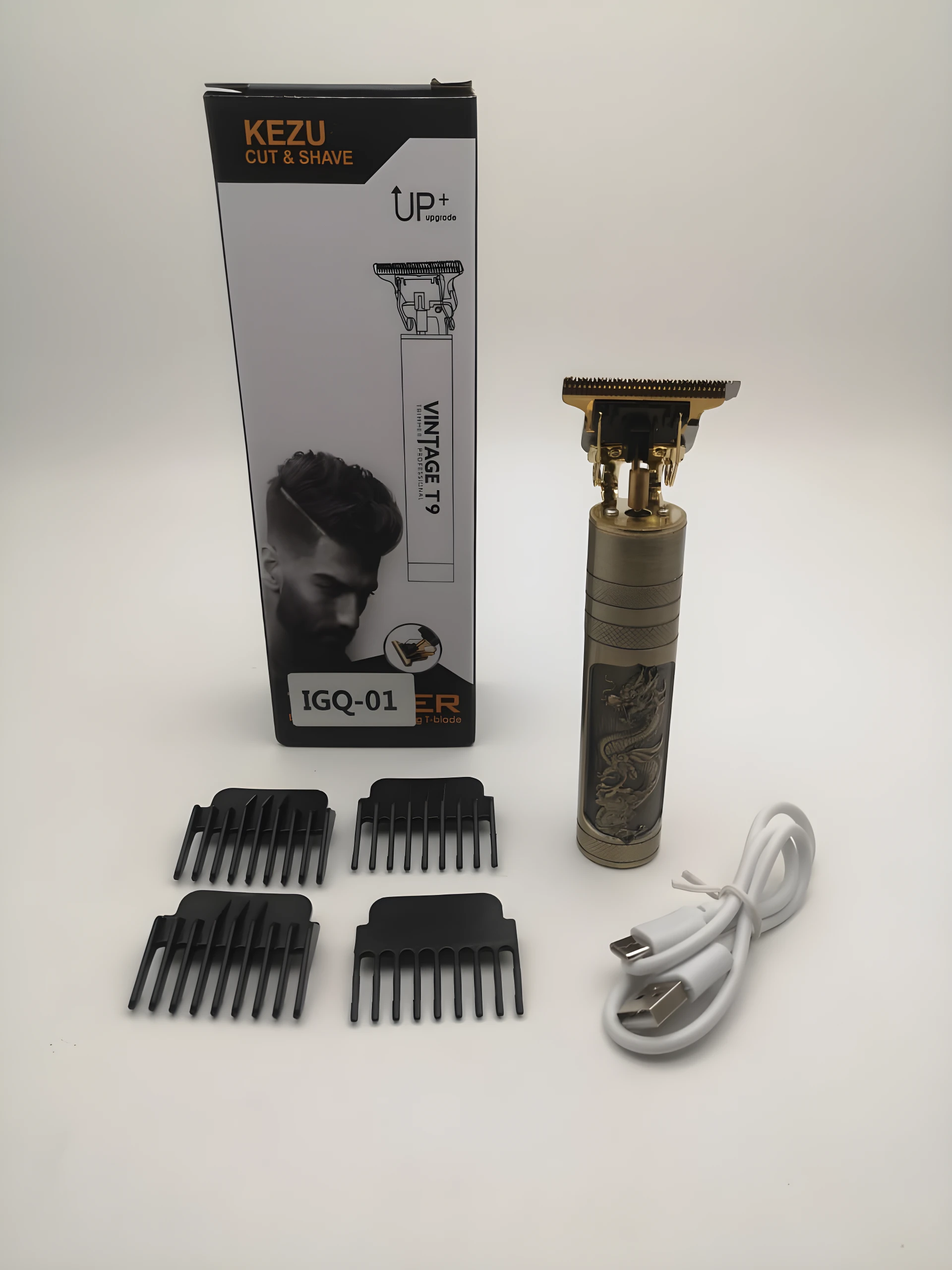 Cortadora de cabello Kezu T9 dorada con grabado de dragón, incluye cuatro guías de corte, cable de carga USB y caja de empaque con diseño profesional.