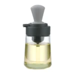 Dispensador de aceite de vidrio con brocha integrada gris, ideal para cocinar.