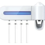 Dispensador de cepillos dentales blanco con luz UV para desinfección y soporte integrado.
