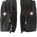 Guantes térmicos negros con cremallera, logo Windstopper y detalles antideslizantes en los dedos y muñeca.
