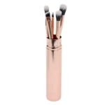 Set de 5 brochas de maquillaje de ojos metálicas rosadas, con cerdas blancas y negras, en un estuche cilíndrico rosado.