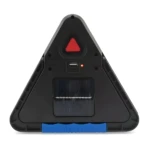 Linterna de emergencia triangular negra con panel solar, puerto USB y botón rojo.