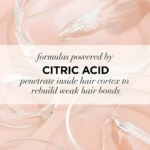 Acondicionador L'Oréal Ácido Cítrico, fórmula transparente sobre fondo rosa pálido, repara cabello dañado.