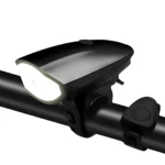 Luz frontal recargable para bicicleta negra 250 lúmenes con bocina, montada en manubrio.