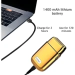 Afeitadora Kemei TX1 dorada cargándose mediante cable USB a una laptop, con batería de 1400 mAh, 2 horas de carga y 120 minutos de autonomía.