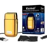 Afeitadora Kemei TX1 dorada con lámina metálica, caja, cable de carga USB, bolsa de tela negra y cepillo de limpieza, diseño profesional de precisión.