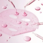 Mascarilla gel rosa con goteros y gotas de PDRN salmón Medicube, ideal para unificar tono y fortalecer la piel.