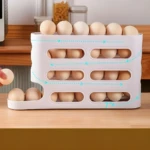 Organizador de huevos blanco de 3 niveles con diseño ventilado y flujo de aire visible en cocina.