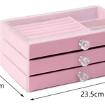 Organizador joyero portátil compacto rosado de 23.5cm x 13.5cm x 11cm con 3 cajones y 3 perillas de cristal.