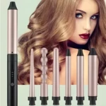 Rizador 6 en 1 de color oro rosa con mango negro, incluye seis cabezales intercambiables de diversos grosores y formas para crear ondas y rizos definidos.