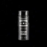 Envase cilíndrico negro de polvo texturizador para cabello Immetee de 0.5 oz con tapa de rosca, diseño mate y letras blancas que indican volumen.