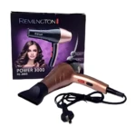 Secador de cabello color oro rosado con boquilla concentradora y cable eléctrico, frente a su caja original modelo RE-2005 Power 3000 sobre fondo blanco.