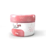 Envase rosa con diseño de hojas de cannabis, contiene "Clarifier 30g" para despigmentar piel.
