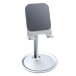 Soporte de celular plateado en aluminio, diseño moderno con base redonda y bandeja ajustable.
