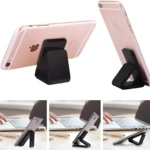 Set x2 soportes celulares negros Fixate Gel, plegables, ideales para mesa y escritorio.