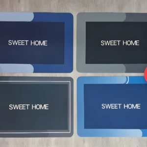 Set x2 tapetes absorbentes: azul oscuro con marco gris azulado, gris oscuro con marco blanco, gris oscuro con marco gris, y azul con marco azul claro.