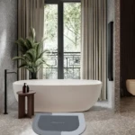 Set x2 tapetes antideslizantes grises y blancos para baño, diseño moderno, absorbentes, con textura de terrazzo en el suelo.