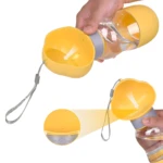 Termo dispensador de agua amarillo para mascotas, con comedero acoplable y botón de encendido/apagado.