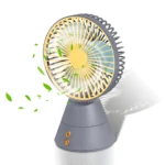 Ventilador de mesa recargable gris y amarillo, giratorio, con aspas de aire y hojas simuladas