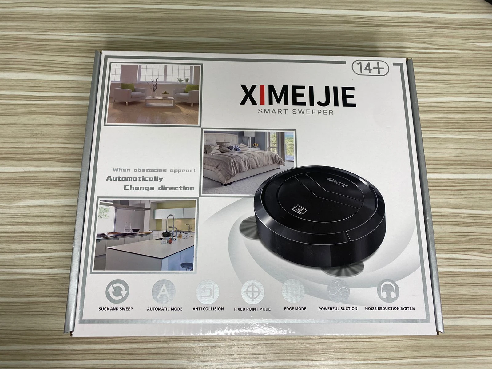 Robot aspirador recargable negro XIMEIJIE en su caja, con ilustraciones de ambientes limpios y detalles de funcionamiento automático.