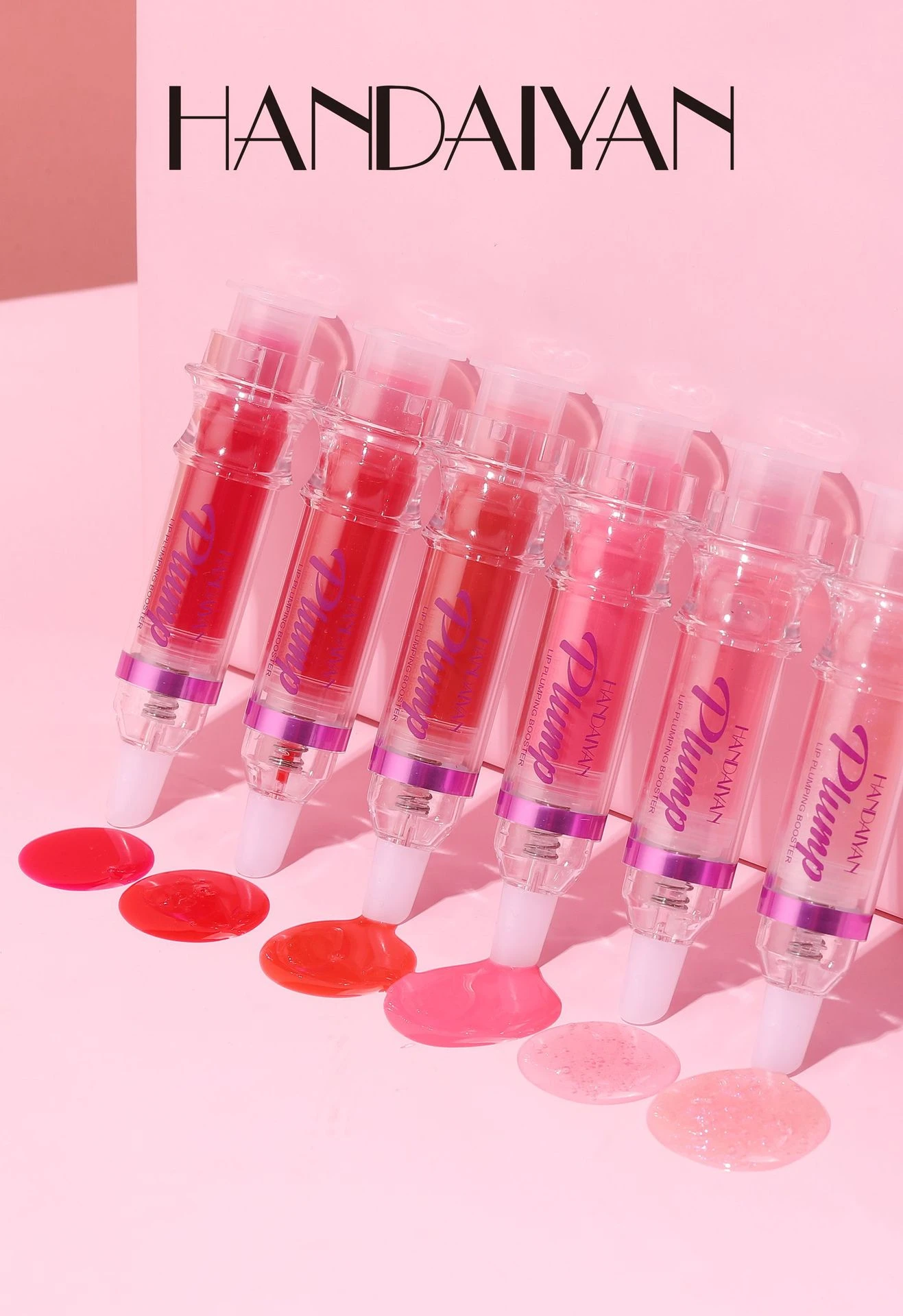 Voluminizador de labios HANDAIYAN en forma de jeringa, varios tonos rosados y rojos, brillo líquido y textura suave.