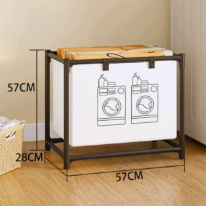 Cesto de ropa sucia con marco metálico oscuro y bolsa blanca con dibujo de lavadoras. Mide 57cm de alto y ancho, y 28cm de profundidad. Diseño plegable para organizar ropa.