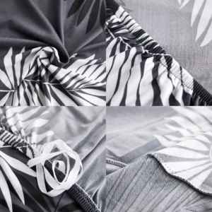Funda elástica para sofá con estampado de hojas en blanco y negro, mostrando detalles de costura, elástico y textura del tejido.