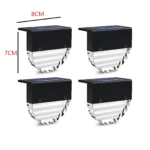Cuatro luces solares LED RGB modelo XF-5013, de 8 cm de ancho por 7 cm de alto, con panel solar superior y carcasa negra.