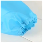 Manga de babero delantal azul para bebé, elástico y con costura.