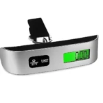 Báscula digital portátil con carcasa plateada y banda negra. Pantalla LCD verde y botones de control visibles. Muestra 0.00 kg.