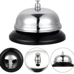 Campana de servicio plateada y negra para hotel, con base redonda y botón superior.