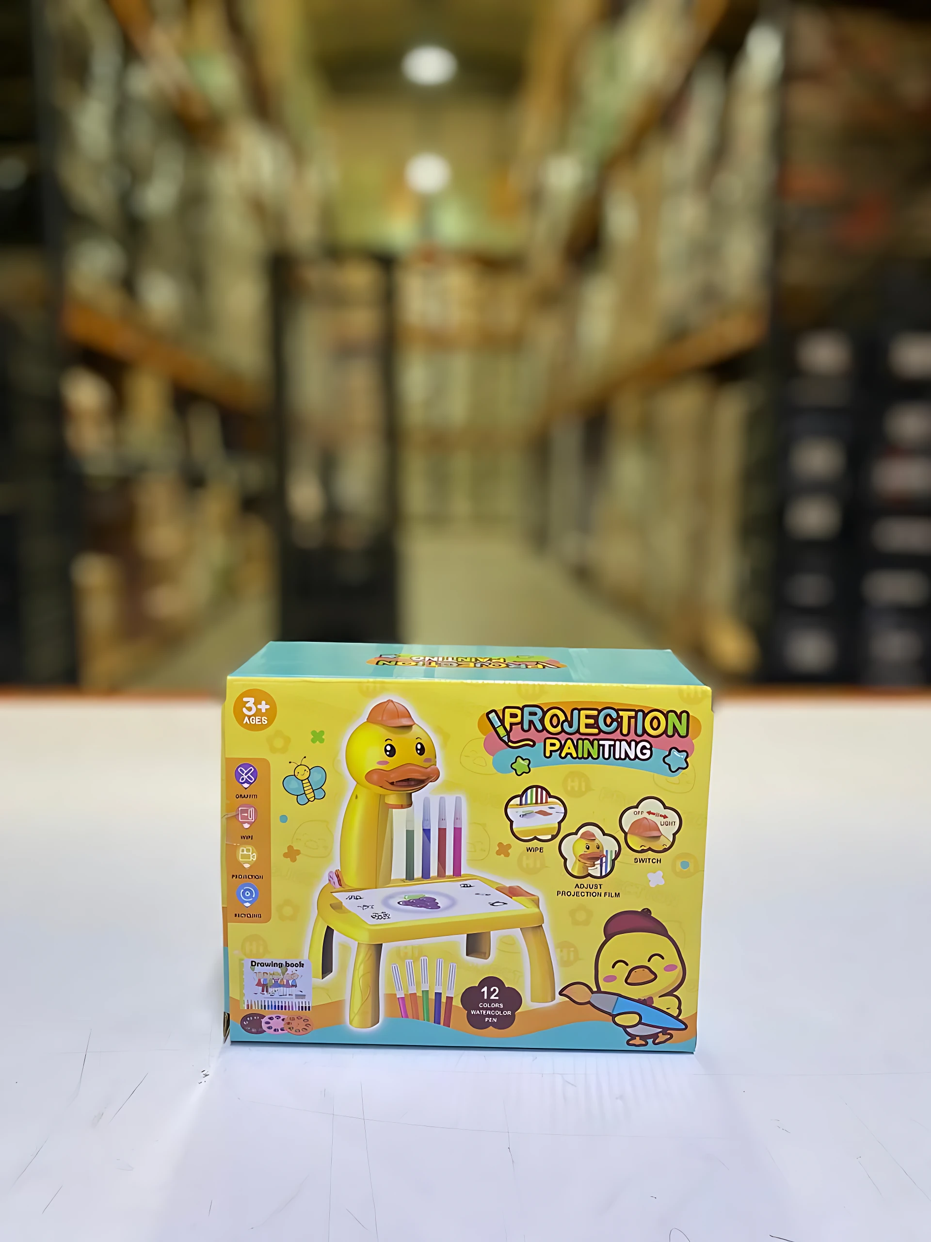 Caja amarilla del juego de pintura por proyección para niños, con de pato y accesorios incluidos.