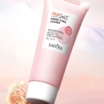 Tubo rosado Sadoer Pink Salt Purifies Pores Cleanser 100g con flor y roca.