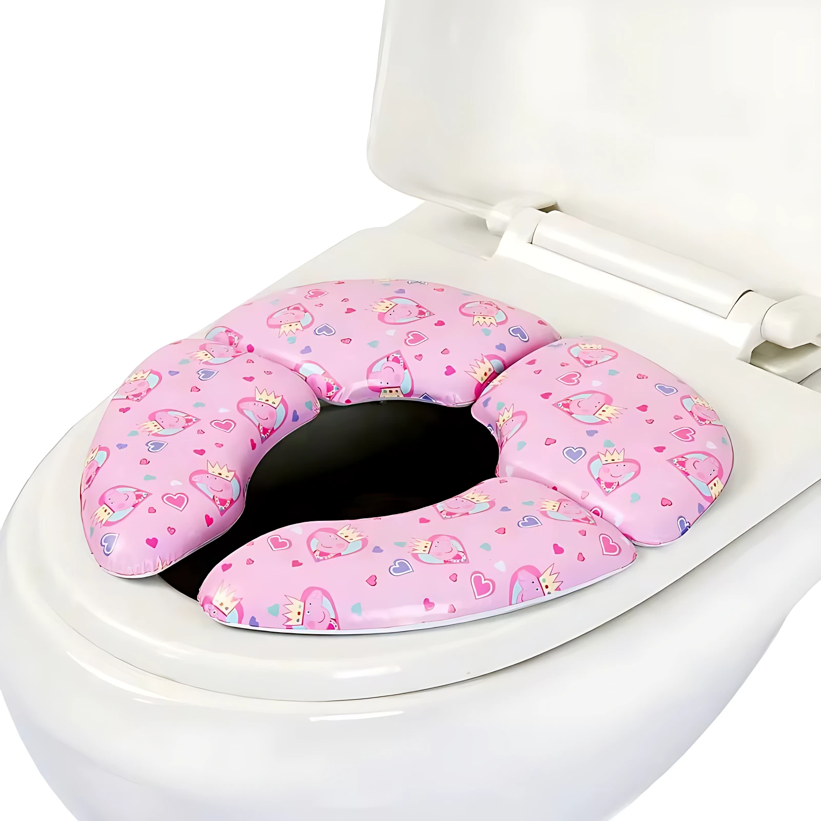 Reductor de baño portátil plegable de espuma rosa con estampado de corazones y unicornios, colocado sobre inodoro blanco.