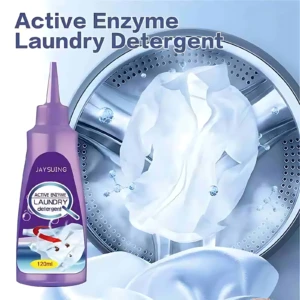 Botella de 120 ml de removedor instantáneo de manchas con enzimas activas, color morado, junto a una prenda blanca siendo lavada en tambor de máquina.