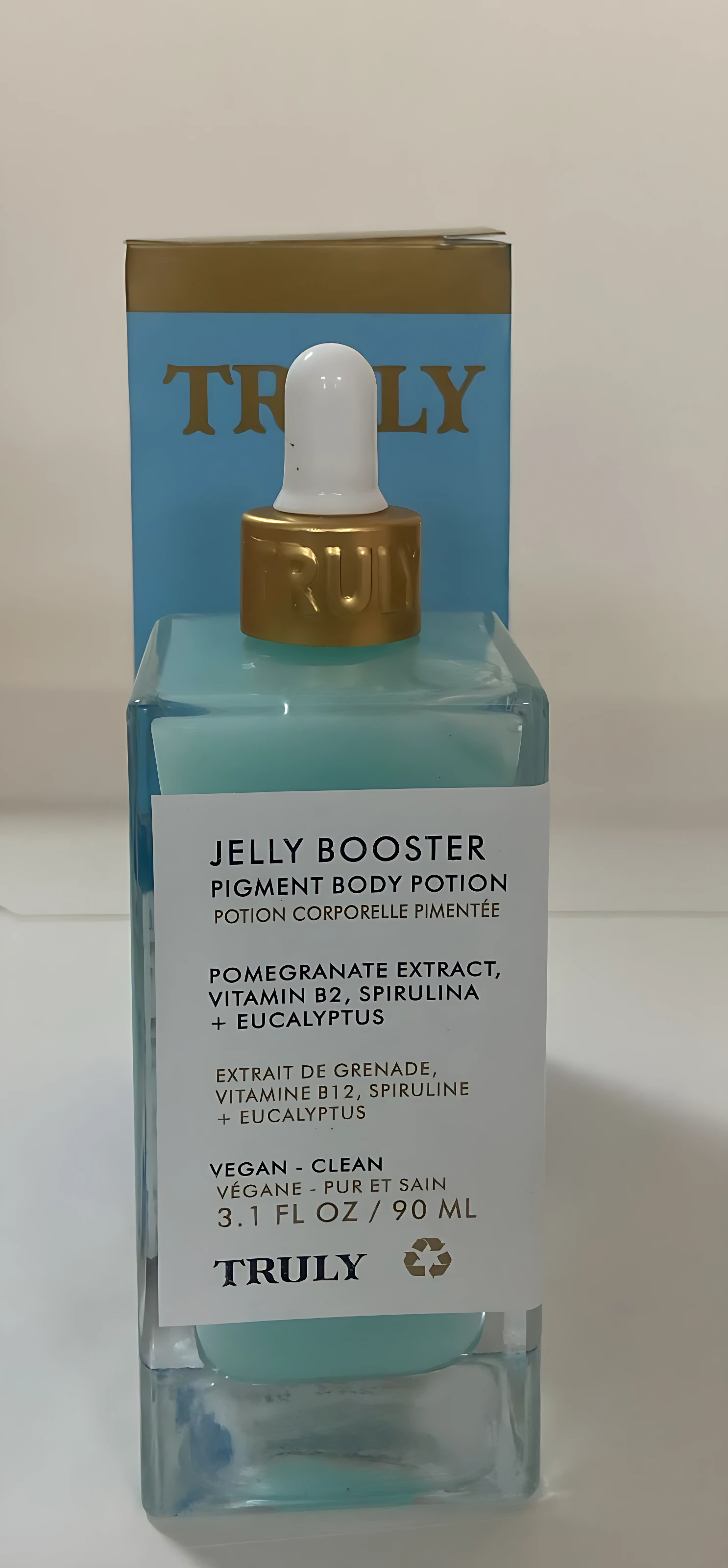 Serum Jelly Booster Truly 90ml, envase de vidrio azul con gotero dorado, ideal para potenciar la pigmentación.