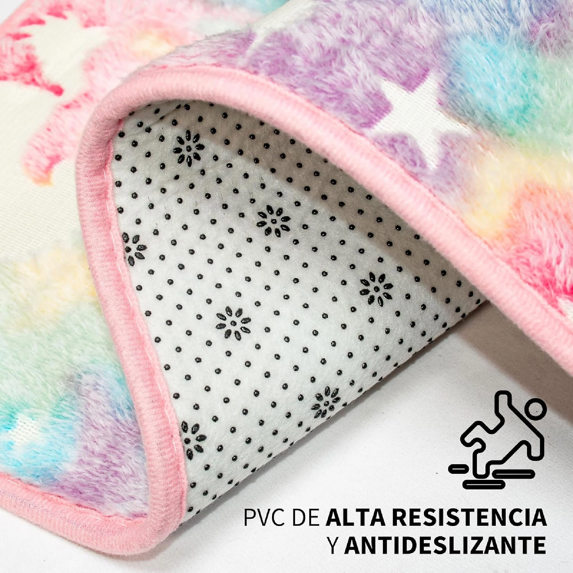 Alfombra felpudo con borde rosa, superficie de colores pastel y reverso antideslizante con puntos negros sobre fondo blanco.
