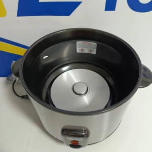 Vista interior de olla arrocera Dkasa de acero inoxidable, con tapa metálica y panel de control frontal; fondo blanco con logotipo parcial visible.