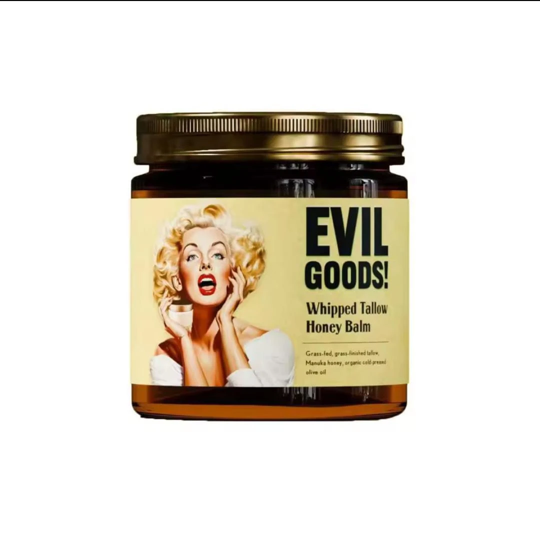 Jarra de vidrio con tapa dorada que contiene crema Evil Goods, etiqueta con retrato de Marilyn Monroe y texto en inglés.