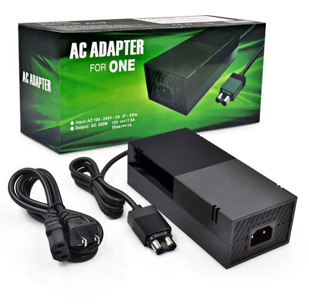 Fuente de alimentación externa negra para Xbox One, con cable de corriente enchufable y conector USB-C, mostrada junto a su caja verde con especificaciones técnicas visibles.